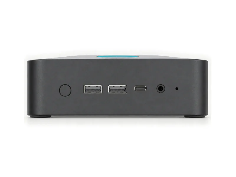 Compact graphite mini PC with round power button, two front USB-A, USB-C and audio on a light studio background