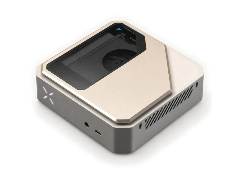 Champagne and gunmetal edge AI mini PC with transparent top window on a light studio background