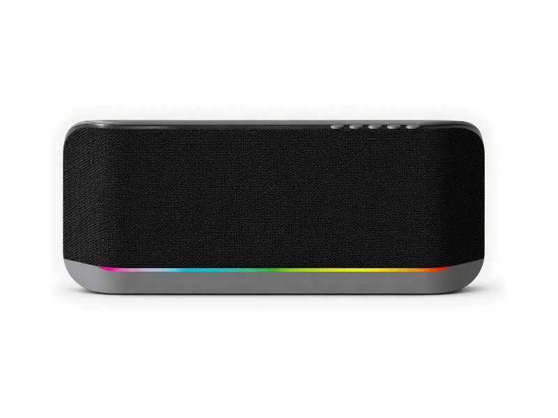 Black oblong wall speaker with gray lower base and thin rainbow light line on a light studio background