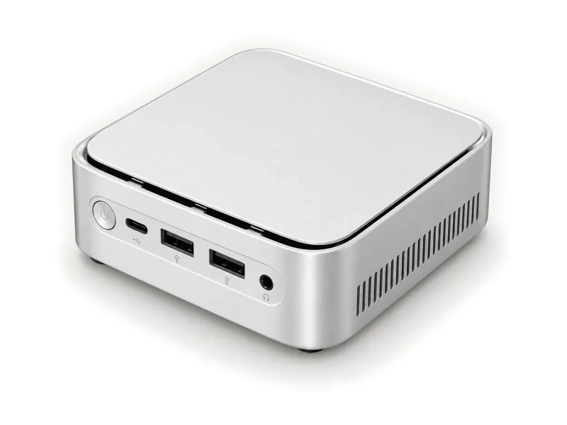 Pale silver mini PC with black lid seam and USB-C front port on a light studio background