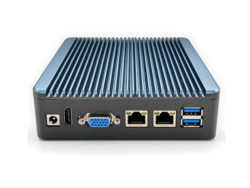 Compact graphite fanless mini PC with blue-gray finned top and dual Ethernet on a light studio background