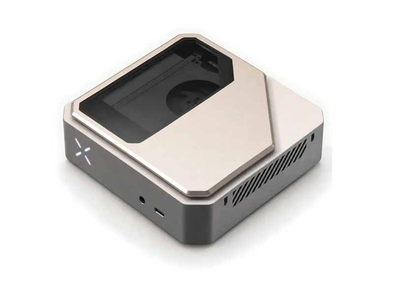 Champagne silver compact computer with a tinted inset lid on a light studio background