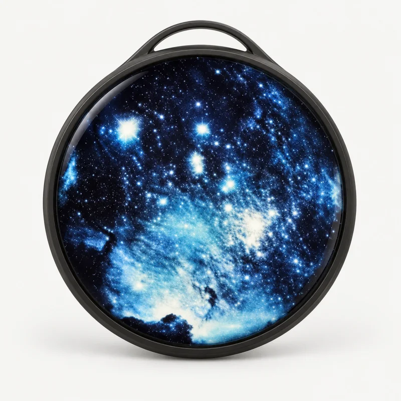 Round dark digital badge with galaxy display and hanging loop on a light studio background