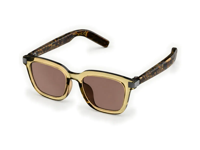 Champagne-frame smart sunglasses with brown lenses and tortoiseshell temples on a light studio background