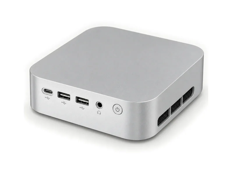 Silver mini PC with three front USB connectors on a light studio background