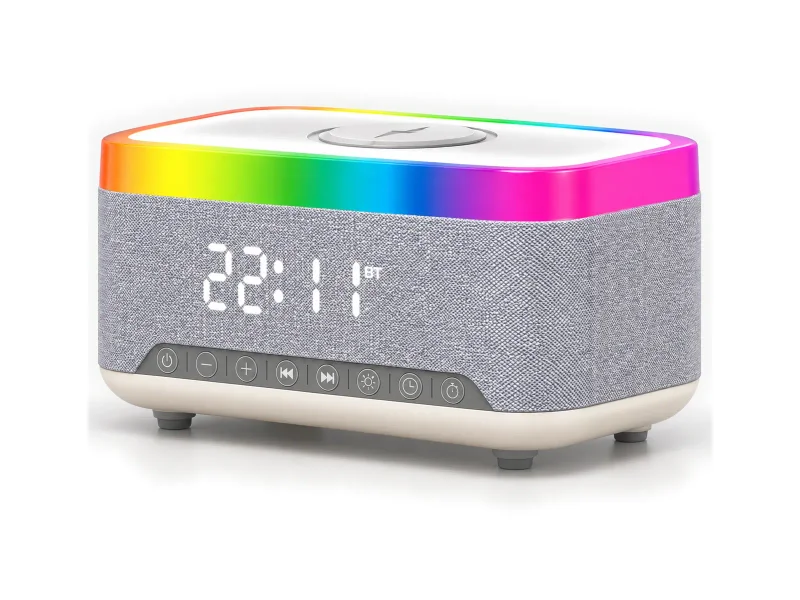 Grey fabric clock speaker with rainbow top light and white charging target on a light studio background